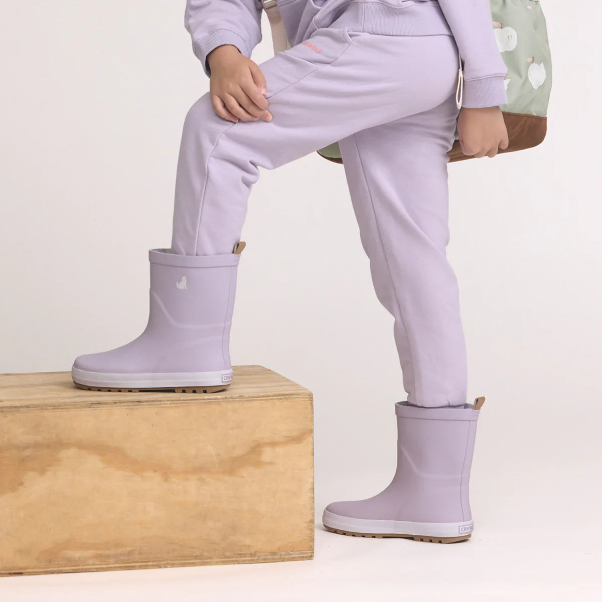 Child wearing Crywolf Rain Boots Heather outdoors