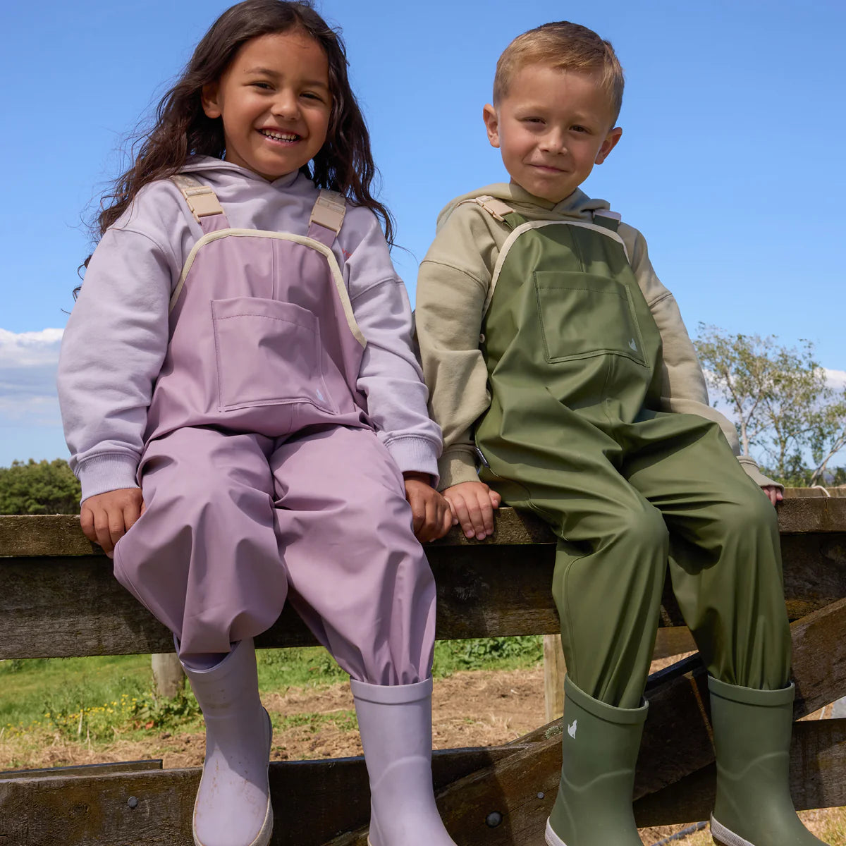 Child wearing Crywolf Rain Overalls Heather outdoors