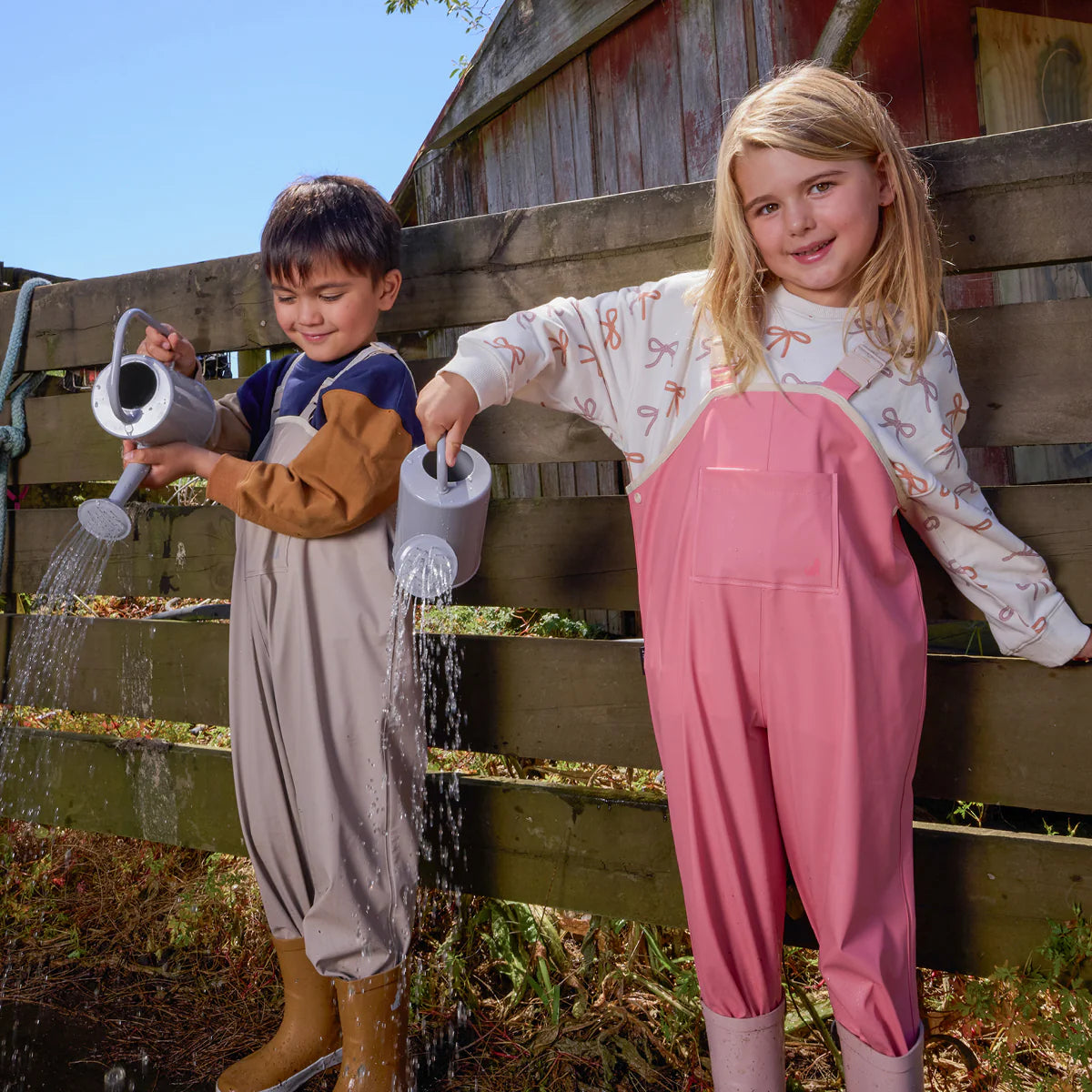 Child wearing Crywolf Rain Overalls Rose outdoors