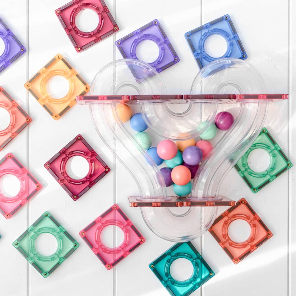 Close-up of pastel Connetix magnetic tiles and ball run tube components