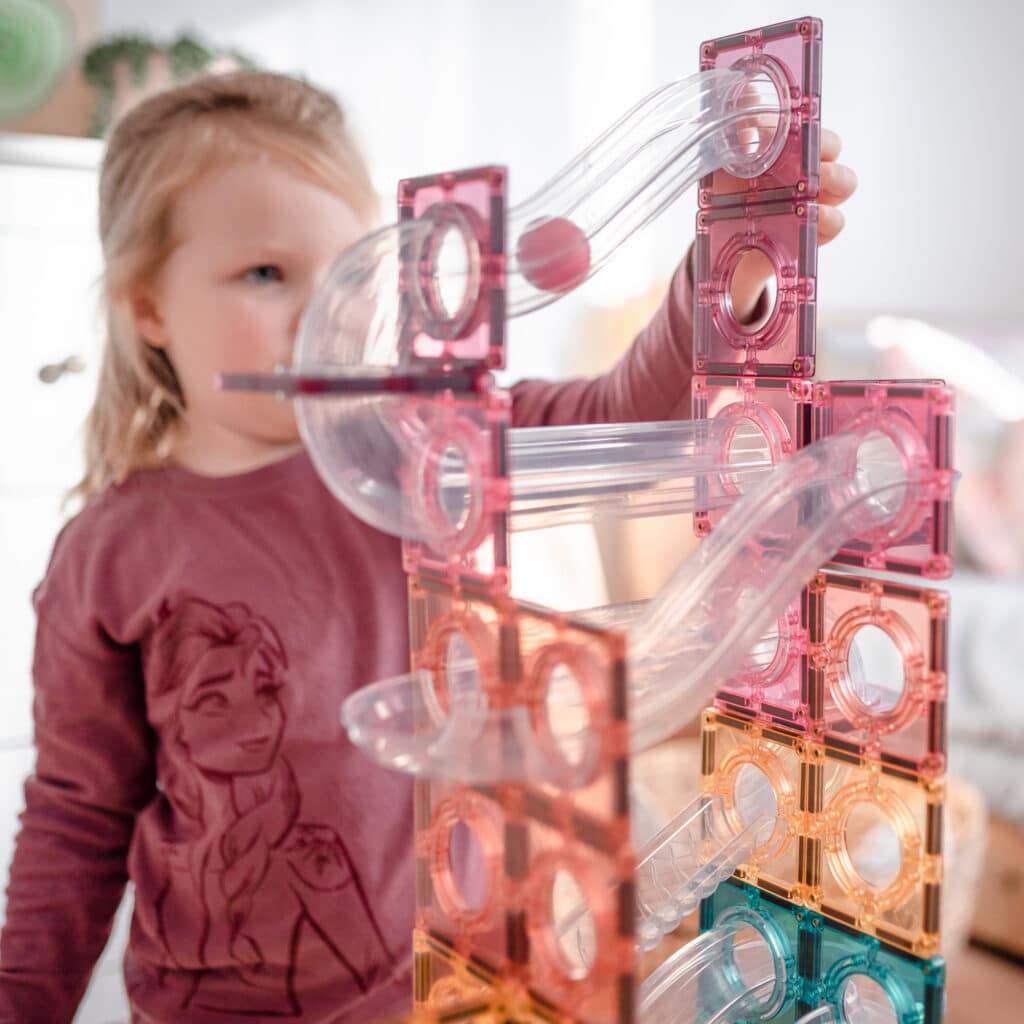 Children playing with the Connetix Pastel Ball Run magnetic tile set