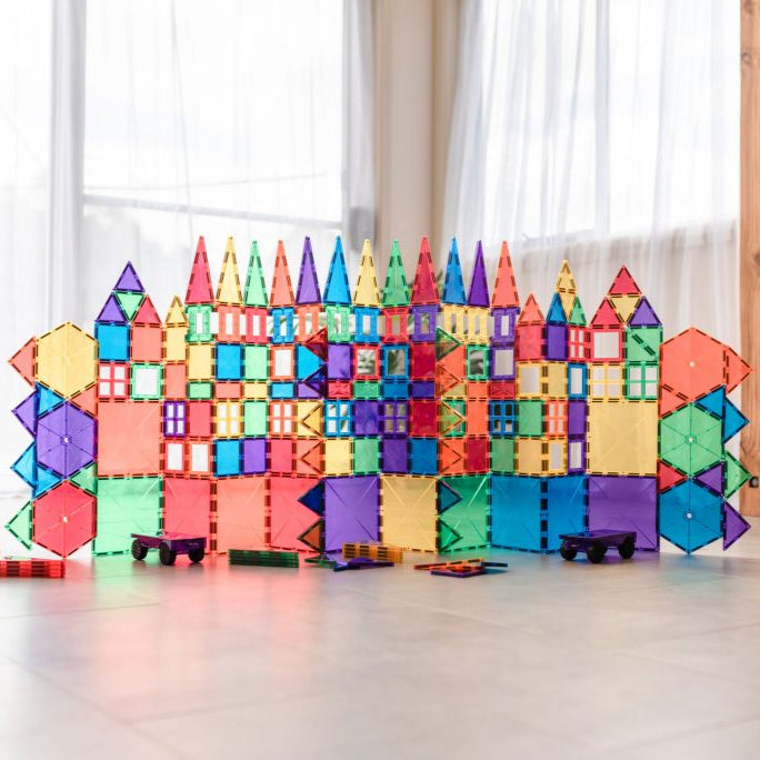 Children building structures with Connetix magnetic tiles