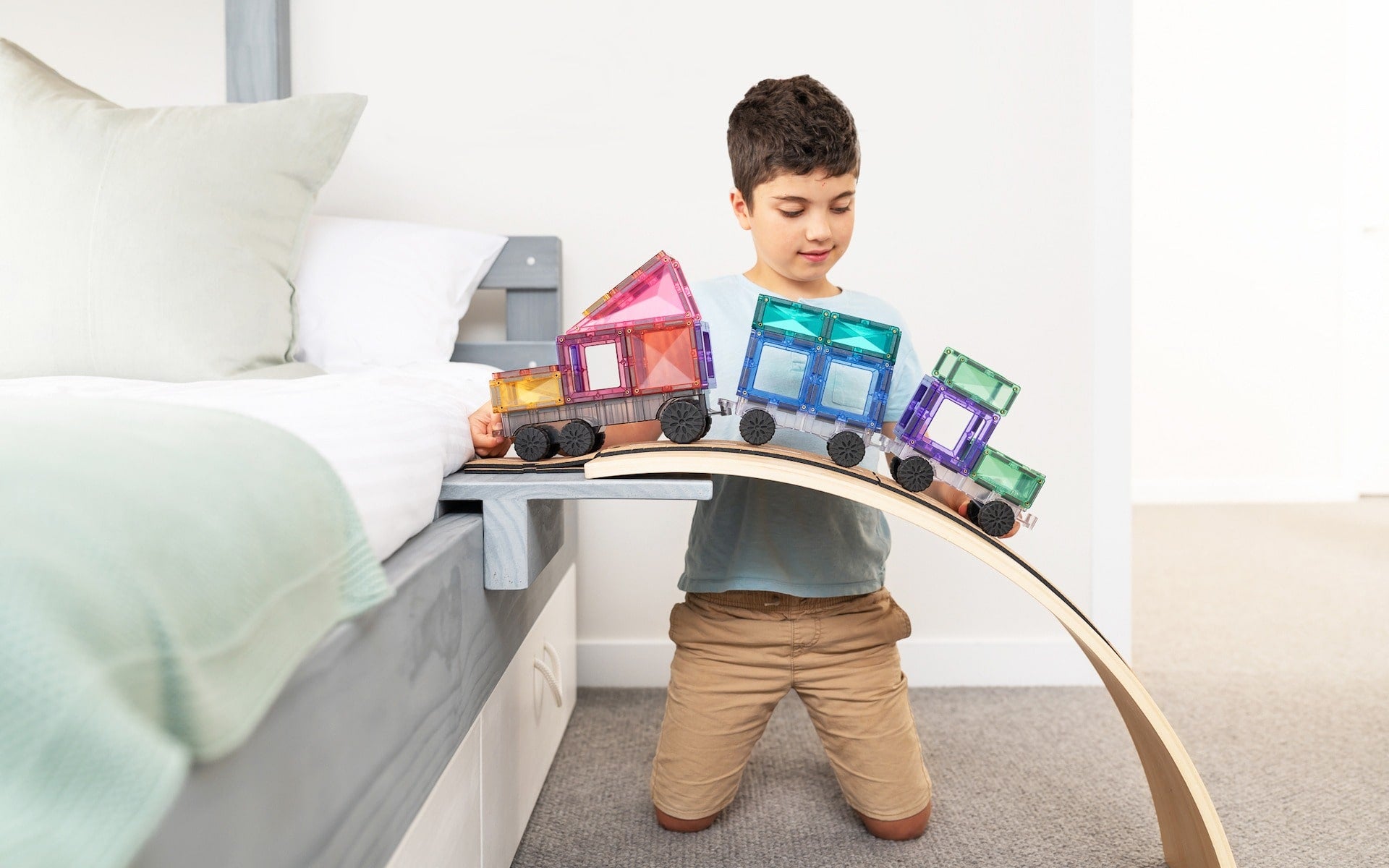 Children playing with Connetix Pastel Transport Pack – magnetic car and train pieces in action"
