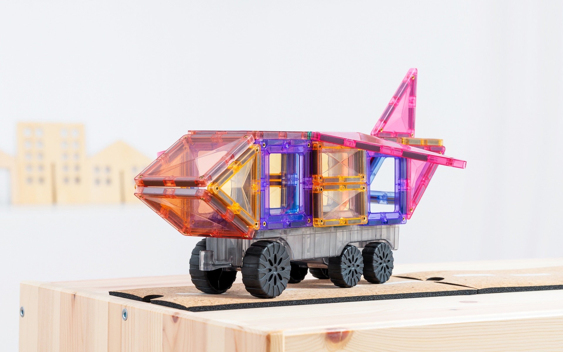Children playing with Connetix Pastel Transport Pack – magnetic car and train pieces in action"