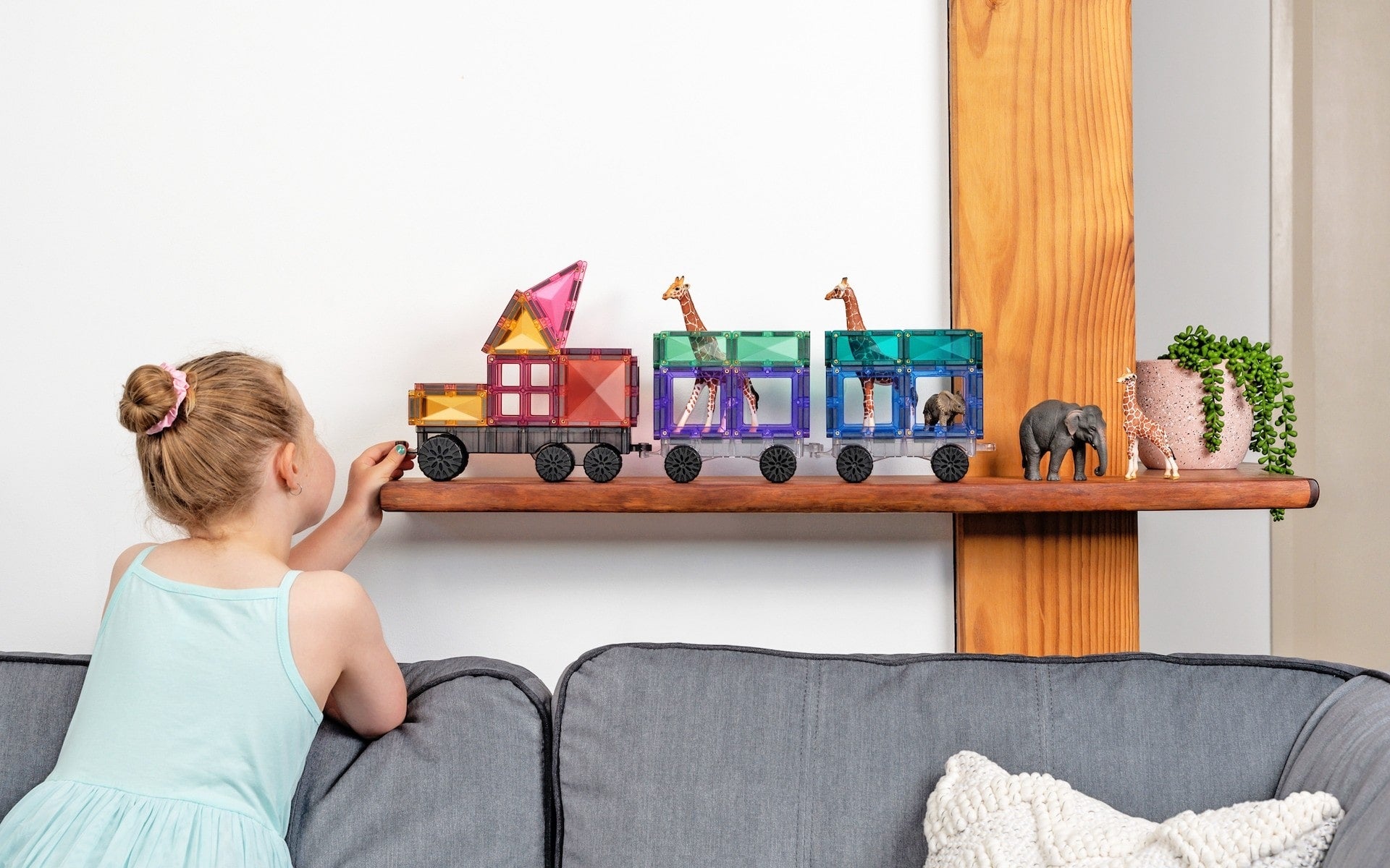 Children playing with Connetix Pastel Transport Pack – magnetic car and train pieces in action