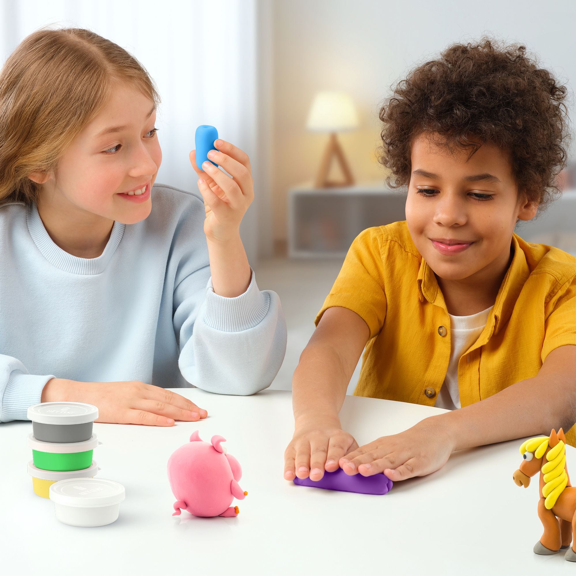 Two children playing with colourful hey clay mega animal set