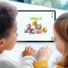 Two children looking at a tablet displaying animal illustrations. Hey clay animal mega set